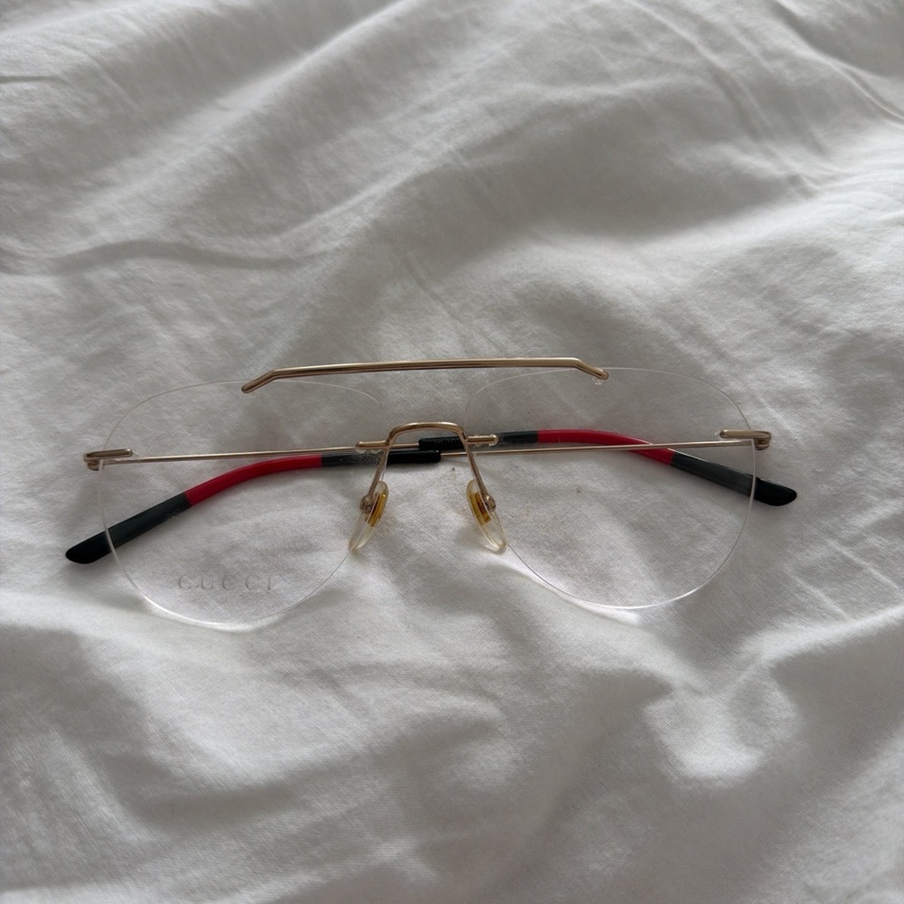 Gucci Rimless Eyewear with Red and Gold Details